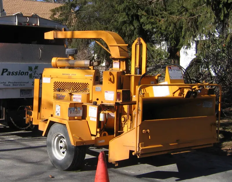 The Passion For Trees chipper and branded truck set up on a job site