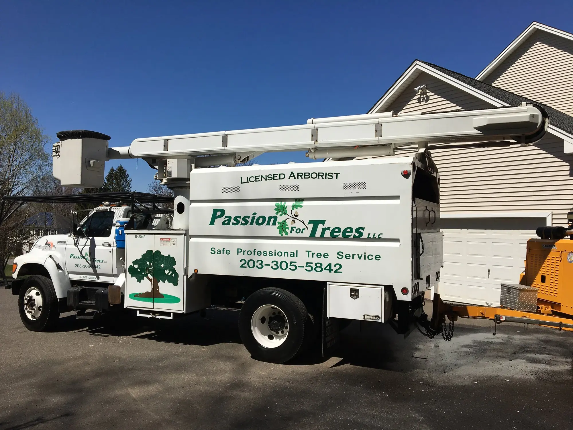 Passion For Trees bucket truck lettered Licensed Arborist, Safe Professional Tree Service, 203-305-5842, parked at a Connecticut job